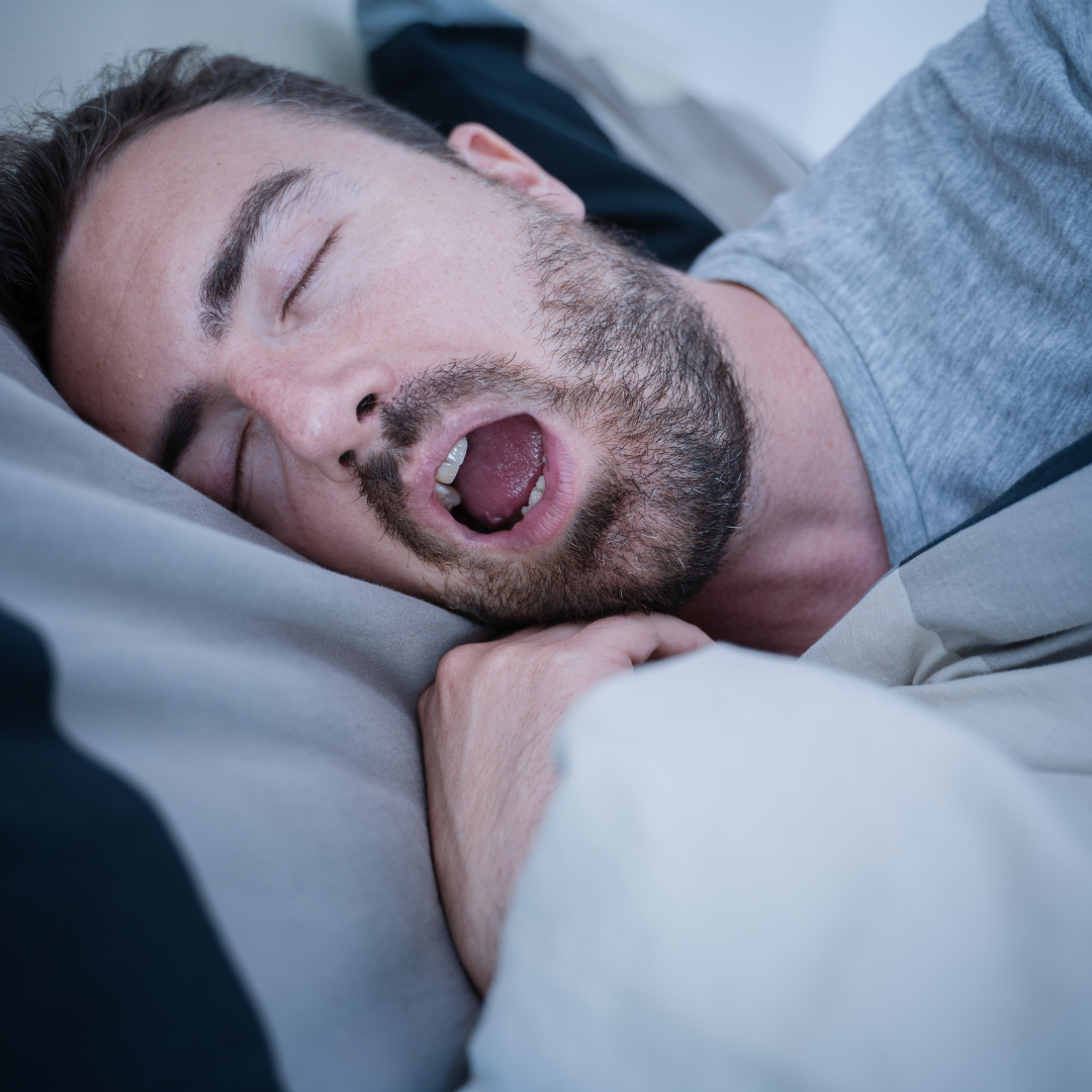 Man sleeping on his side with mouth open, illustrating mouth breathing during sleep